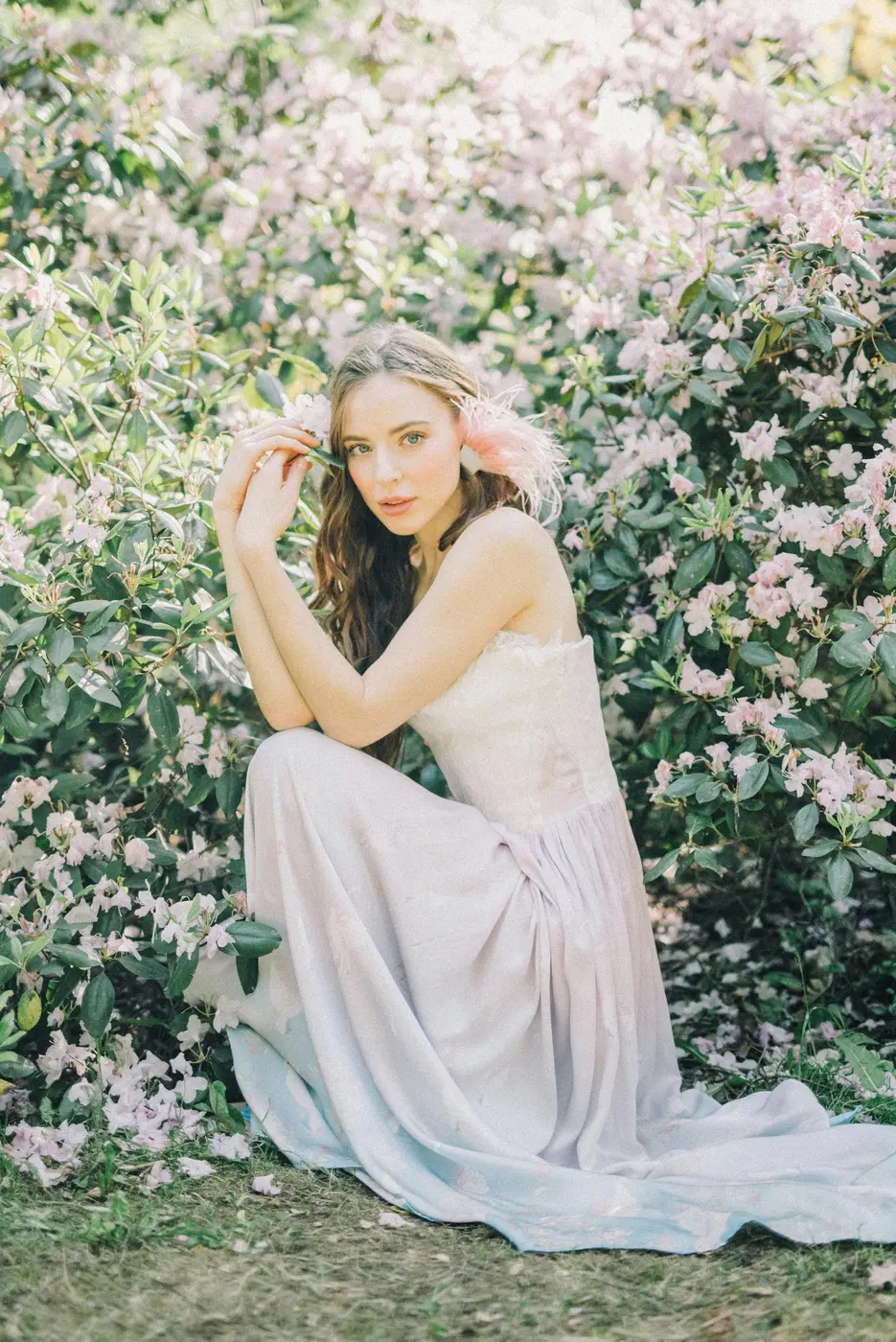 Bride in a wedding dress beneath blossom